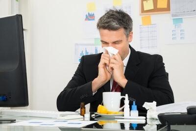 Man blowing his nose in the office is the reason offices should have professional cleaning