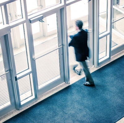 Man walking out of a clean corporate office building