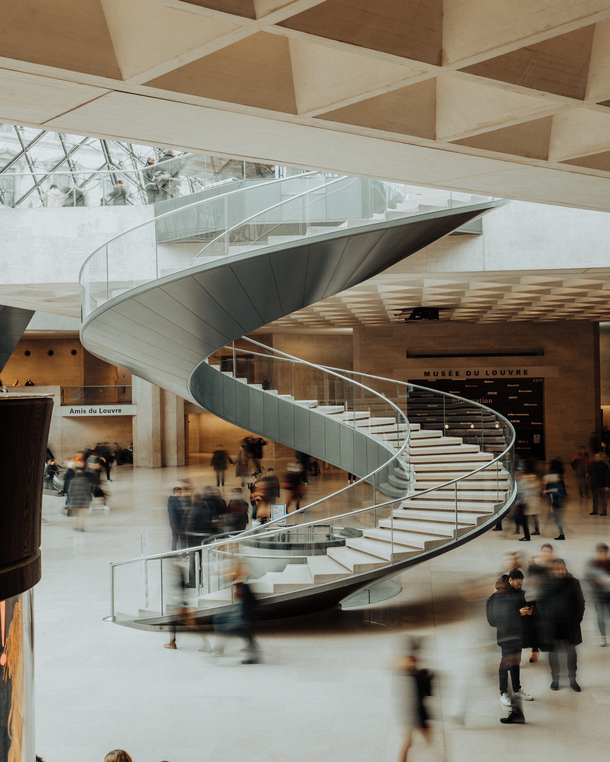 Large white marble spiral staircase in museum